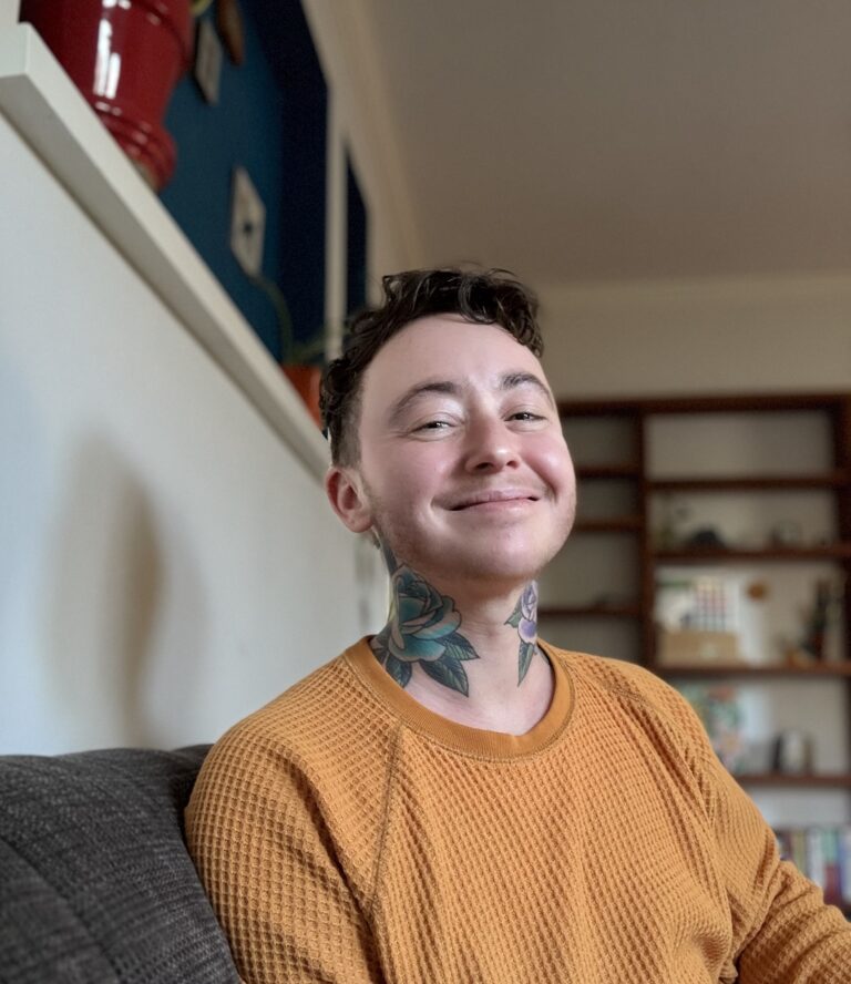 Lane sitting on a couch smiling