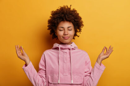 Relieved woman stands in lotus pose