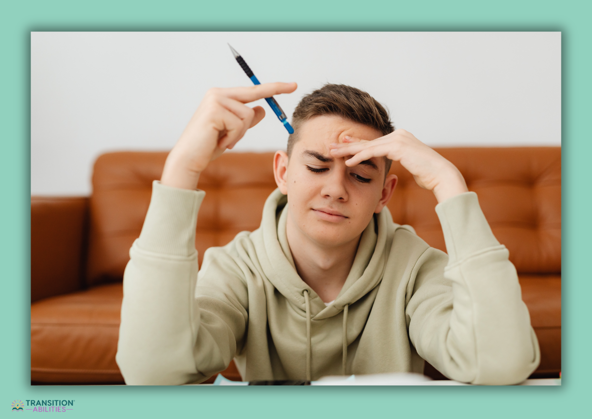 Teen student thinking while holding pencil