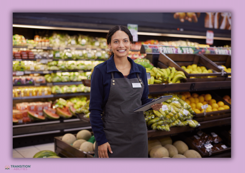 Grocery store worker holding tablet in produce section
