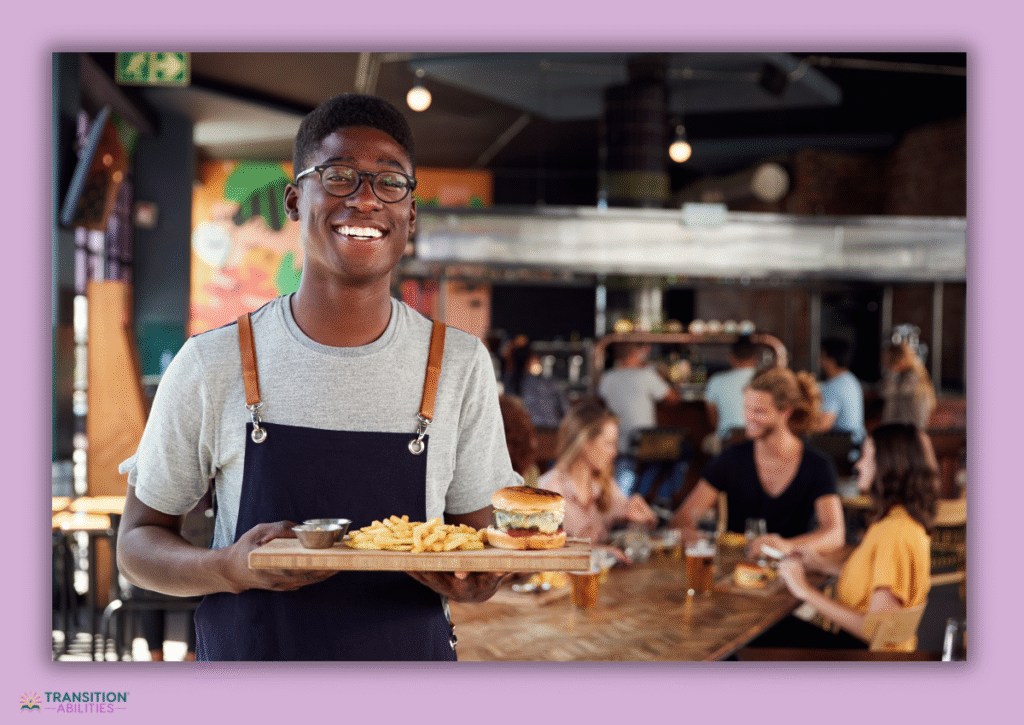 Restaurant worker holding burger and fries tray