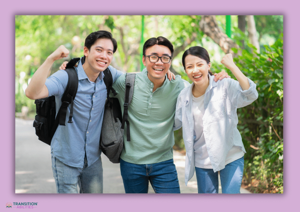Three smiling students posing outdoors