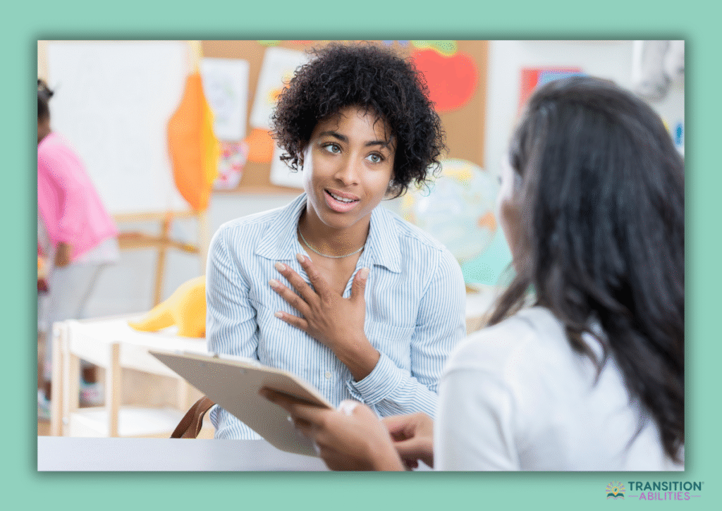 Teacher talking with student while holding a clipboard