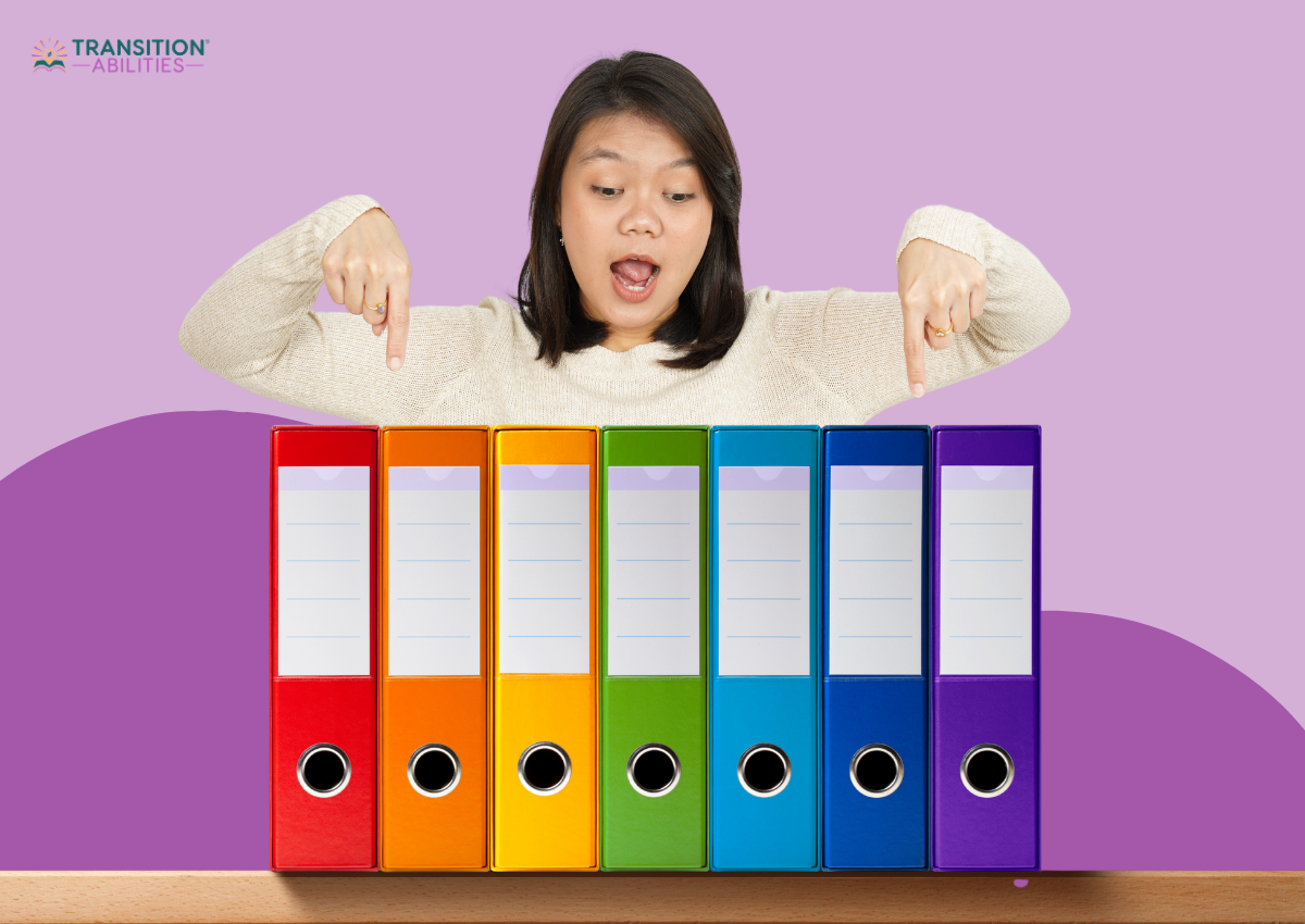 Woman pointing at colorful binders lined up on a table