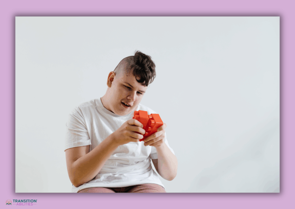 Student examining a red fidget puzzle toy