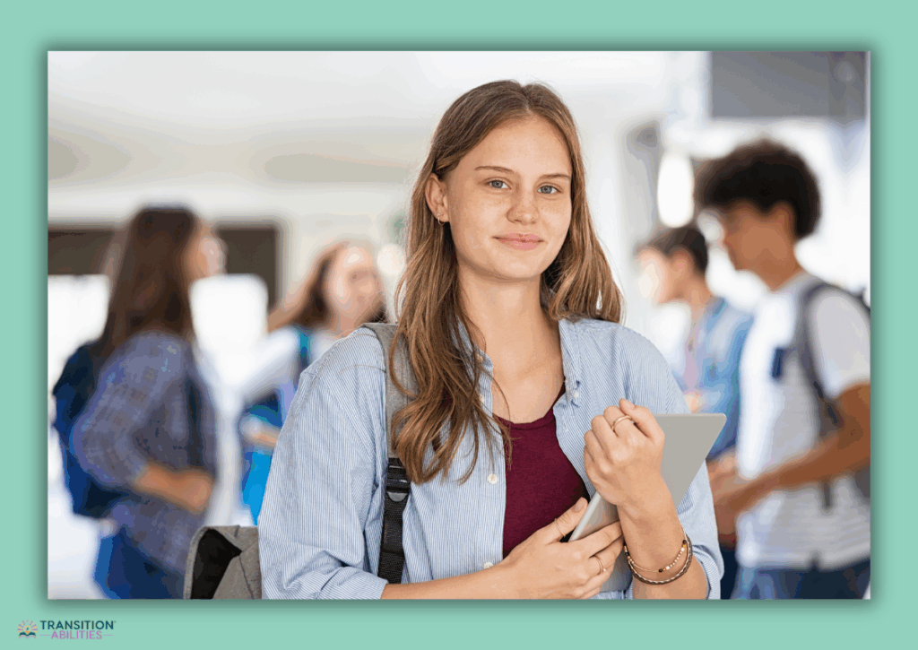 Student holding a tablet in a school hallway