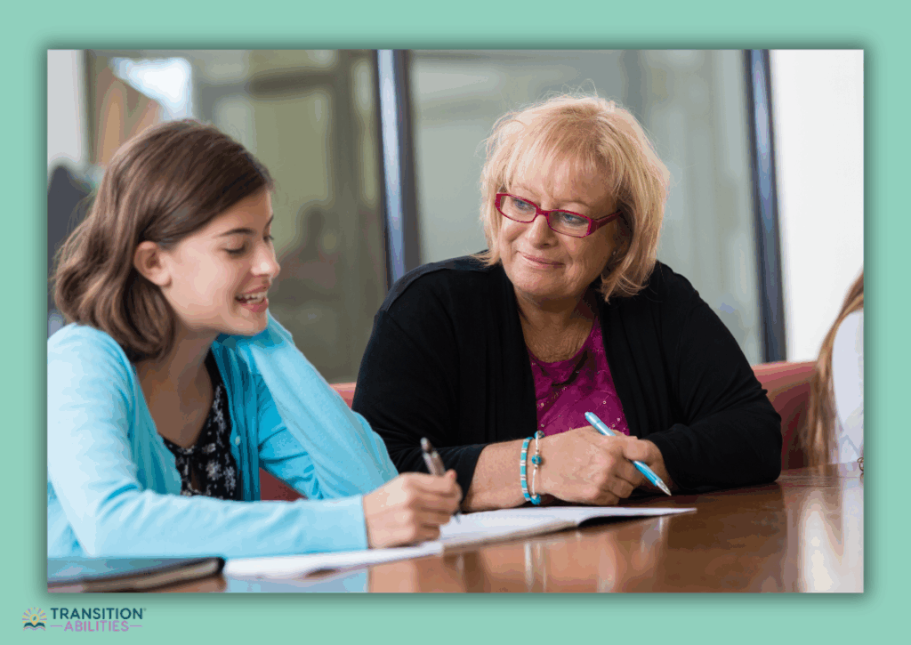 Teacher helping student with writing at a table