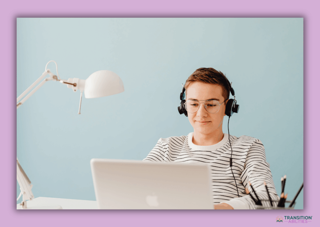 Teen using a laptop with headphones at a desk