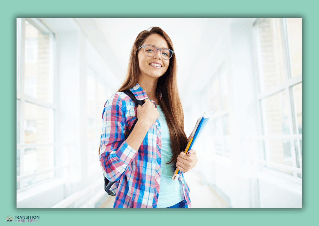 A student with a backpack holds books while standing in a school hallway.
