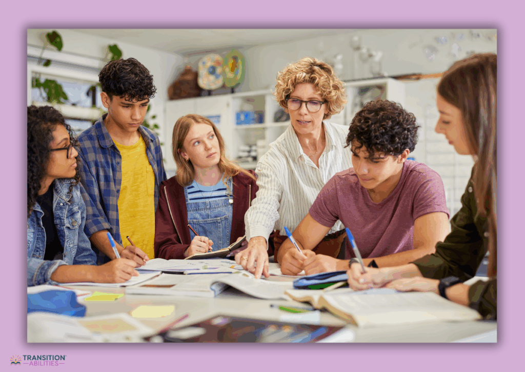 A teacher guides a small group of students working together at a table.