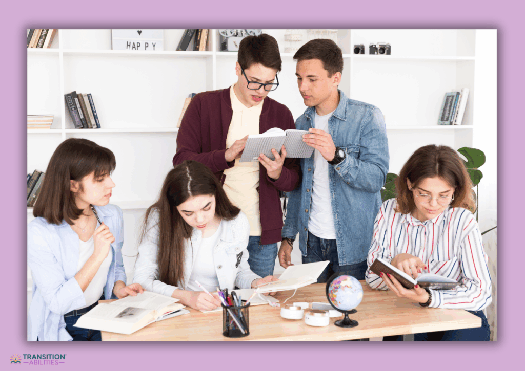A group of students study together at a table with books and notebooks.