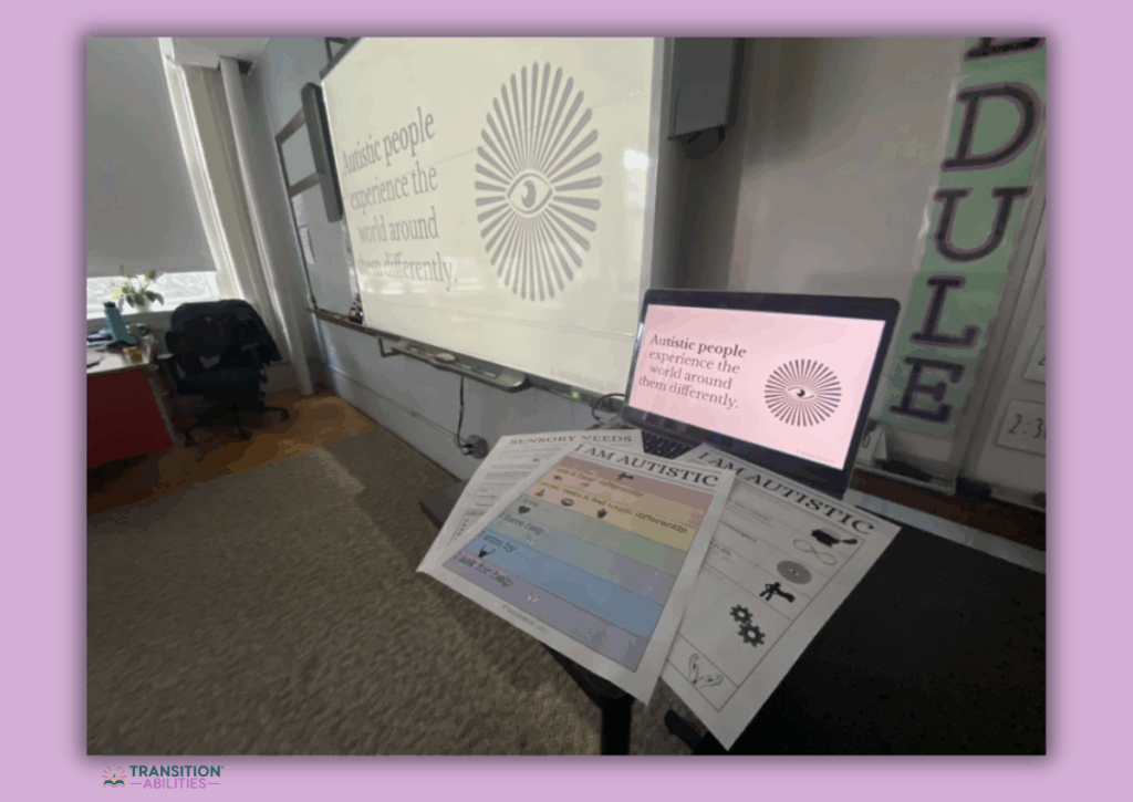 Classroom setup showing an autism awareness presentation with worksheets on a table.