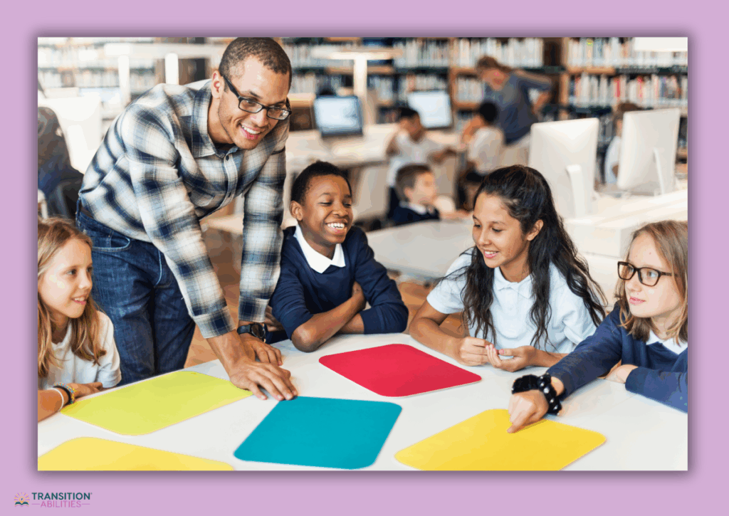 A teacher and students sit around a table participating in a learning activity.