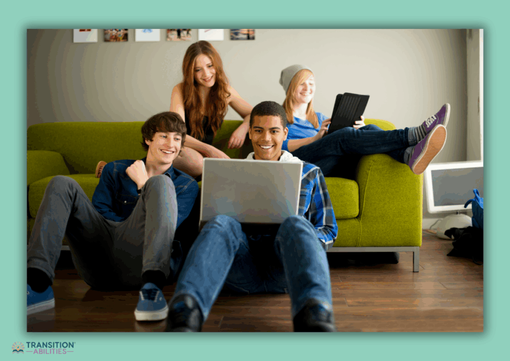 Group of teenagers sitting on the floor and couch enjoying a video on a laptop
