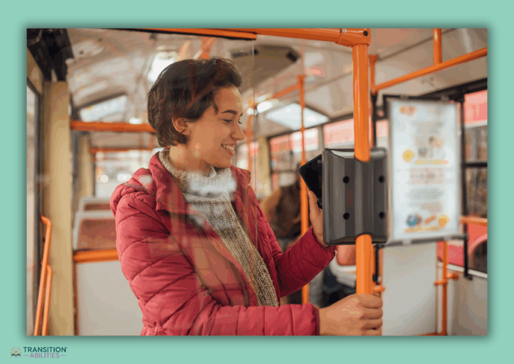 Person in a red jacket using a card reader on public transportation.